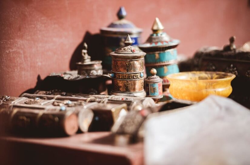 Assorted traditional Arab containers and ornaments on a red backdrop