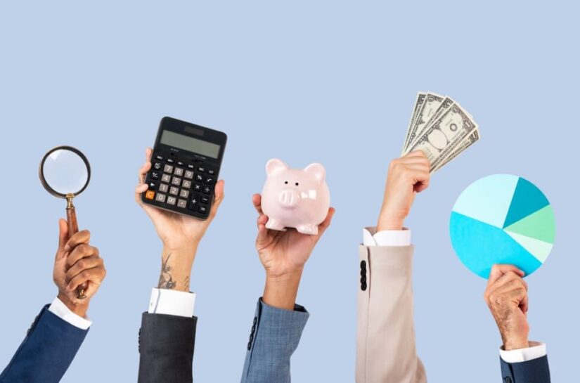 Hands holding financial tools: magnifier, calculator, piggy bank, cash, pie chart