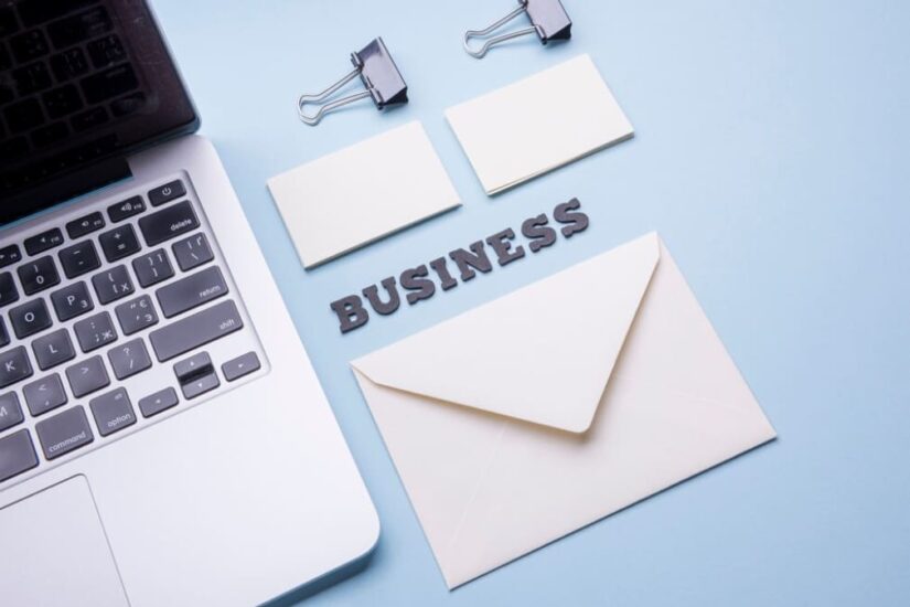 A laptop with business-related items on a blue background