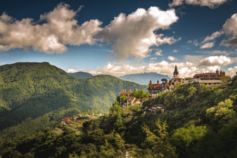 A scenic view of a European village nestled in green hills